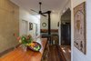 Modern home with Dining Room, Table, Recessed Lighting, Storage, Accent Lighting, Medium Hardwood Floor, and Wood Burning Fireplace. Dining room table and restored slow combustion cook top at centre of plan. Photo 8 of Kihilla