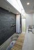 Modern home with Ceiling Lighting. Off form concrete bath hidden below timber trapdoor. Photo 15 of Kihilla