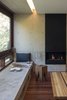 Modern home with Living Room, Bench, Stools, Recessed Lighting, and Gas Burning Fireplace. Living room daybed and fireplace composition. Photo of Kihilla