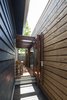 Custom pivot doors off dining room between new and existing. Photo 11 of Kihilla modern home