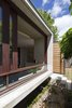 Modern home with Exterior, House Building Type, Metal Roof Material, Wood Siding Material, Concrete Siding Material, Glass Siding Material, and Flat RoofLine. Custom river red gum sliding windows and australian cypress door. Photo 3 of Kihilla
