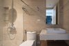 Modern home with Bath Room, One Piece Toilet, Wall Mount Sink, Enclosed Shower, Ceramic Tile Floor, Tile Counter, Ceramic Tile Wall, and Ceiling Lighting. Bathroom Photo 16 of A.D02
