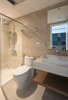 Modern home with Bath Room, Ceiling Lighting, Ceramic Tile Wall, Ceramic Tile Floor, Enclosed Shower, Tile Counter, One Piece Toilet, and Wall Mount Sink. Bathroom Photo 15 of A.D02