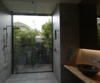 Modern home with Bath Room, Porcelain Tile Floor, Wood Counter, Vessel Sink, Open Shower, Accent Lighting, and Porcelain Tile Wall. guest bathroom shower Photo 2 of HLJH