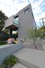Modern home with Outdoor, Front Yard, Trees, Grass, and Concrete Patio, Porch, Deck. front of home cmu block Photo 4 of HLJH