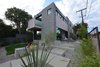 Modern home with Outdoor, Front Yard, Trees, Shrubs, Grass, Walkways, Concrete Patio, Porch, Deck, Concrete Fences, Wall, Metal Fences, Wall, and Wire Fences, Wall. stairs up to outdoor living Photo 5 of HLJH