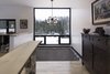 Modern home with Living Room and Accent Lighting. Jean-Yves Rouleau, designer of the Lac Brûlé House, enthuses that the home’s “clean, rectilinear volumes create spaces that intersect, letting light into the sky and give a view of the forest at all times.” Near the living room, a skylight filled with a hammock allows the homeowners to view the stars at night. Photo 14 of Maison Lac Brûlé