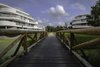 Modern home with Exterior, Apartment Building Type, Green Roof Material, Wood Siding Material, Concrete Siding Material, Stucco Siding Material, Stone Siding Material, and Flat RoofLine. villa A, B and C from bridge Photo 5 of De Haaf Bergen, The Netherlands