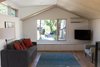 Modern home with Living Room, Chair, Sofa, Medium Hardwood Floor, and Ceiling Lighting. The living room flows right from the kitchen/dining area in this open plan Photo 4 of Division Street ADU