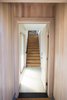 Modern home with Staircase, Wood Tread, and Metal Railing. A void created by the entry frames the stairway. Photo of Division Street ADU