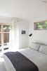 Modern home with Bedroom, Wall Lighting, Concrete Floor, and Bed. Ground floor bedroom features a walk-out patio Photo 6 of Division Street ADU