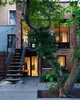 Modern home with Exterior, House Building Type, and Brick Siding Material. Rearyard extension that preserved a 200-year old tree. Photo of Williamsburg Rowhouse
