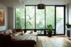 Modern home with Living Room, Medium Hardwood Floor, Sectional, Accent Lighting, and Recessed Lighting. The rearwall was engineered with a large steel lintel, allowing for a full window wall. The result is a light-filled living space that feels part of the garden. Photo 3 of Williamsburg Rowhouse