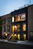 Modern home with Exterior, House Building Type, Shingles Roof Material, and Flat RoofLine. Exterior (nighttime) - Large windows glow Photo 3 of Brooklyn Upside Down with Views