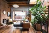 Modern home with Living Room, Medium Hardwood Floor, Wood Burning Fireplace, Pendant Lighting, Console Tables, Floor Lighting, Sectional, Bookcase, Chair, End Tables, and Coffee Tables. Living Level Photo 4 of Brooklyn Upside Down with Views