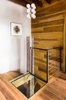 Modern home with Staircase, Wood Tread, and Metal Railing. Spiral stair to basement. Glass floor provides natural light Photo 10 of Brooklyn Upside Down with Views