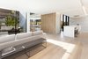 Modern home with Living Room, Bench, Sofa, and Recessed Lighting. Living, Dining, and Family Room – Open-concept design connects with the kitchen through floor-to-ceiling sliding glass doors on each side of an interior courtyard for al fresco enjoyment and/or natural foliage; a sleek corner fireplace by Ortal spans one wall in the living area, and a built-in seating bench under the staircase wall adds functionality to design; a rear wall entirely made of glass integrates sliding glass doors to the covered portico overlooking the serene backyard Photo 3 of Kelly House