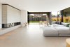 Modern home with Living Room, Gas Burning Fireplace, Two-Sided Fireplace, Ceramic Tile Floor, Ceiling Lighting, Bench, Chair, Sofa, Ottomans, Light Hardwood Floor, and Coffee Tables. Fireplace Photo 8 of Kelly House