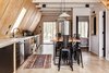 Modern home with Dining Room, Table, Stools, Pendant Lighting, Rug Floor, and Light Hardwood Floor. Vintage run. Reclaimed White Oak Flooring from Provenance Architecturals, Live Edge table, Japanese concrete lights. Photo 12 of Lokal A-Frame