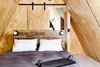 Modern home with Bedroom, Bed, Painted Wood Floor, and Accent Lighting. Pine plywood A-Frame interior and sliding barn door. Custom tray by Peg & Awl. Photo 10 of Lokal A-Frame