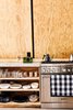 Modern home with Kitchen, Ceiling Lighting, Light Hardwood Floor, Wood Cabinet, and Concrete Counter. Chef's kitchen detail with open plywood shelves. Range by Thermador Photo 17 of Lokal A-Frame