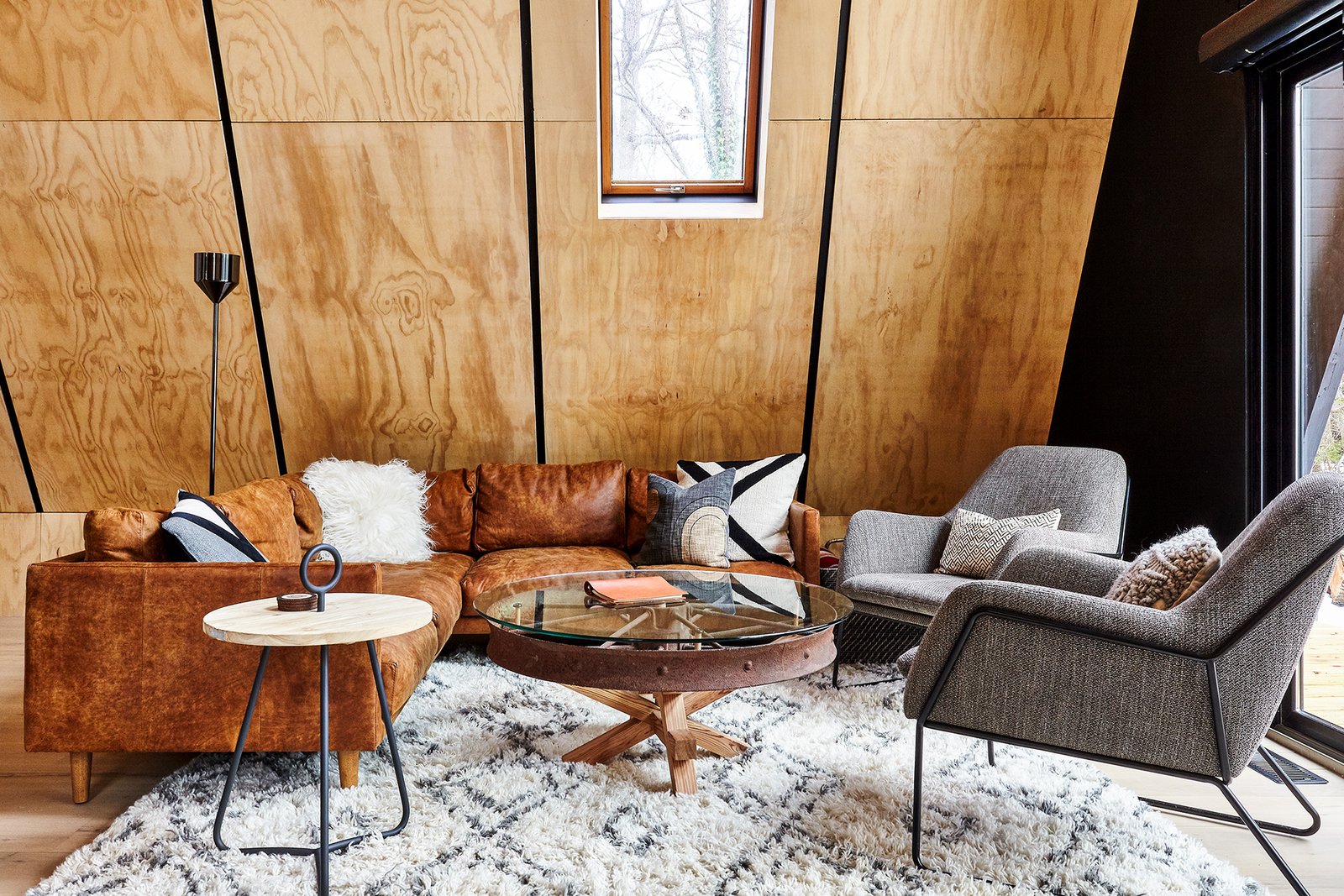 Living room with furnishings by Article & custom wagon wheel table by Ovuud