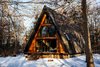 Front facade with firewood stacked beneath new cedar deck Photo 19 of Lokal A-Frame modern home