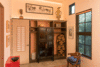 Modern home with Chair, Bench, Shelves, Recessed Lighting, Accent Lighting, and Concrete Floor. The closet wall is crafted from reclaimed wood, split bamboo wall covering and a C1900 Chinese chest. A sandblasted glass urn in a style reminiscent of topiary, by glass artist Janis Miltenberger depicts the popular Aesops fable of the pitcher and the crow. Photo 14 of The Barn Gallery