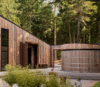 Modern home with Exterior, House Building Type, Metal Roof Material, Wood Siding Material, Metal Siding Material, and Shed RoofLine. This rain storage tank is a feature to be displayed at the entrance and not hidden away, as so often is the case. Sustainable infrastructure can be beautiful. Photo 8 of The Barn Gallery