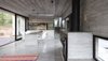 Modern home with Dining Room, Table Lighting, Chair, Table, Concrete Floor, and Wood Burning Fireplace. Wein House - Besonías Almeida arquitectos Photo 8 of Wein House