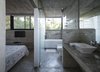 Modern home with Bath Room, Concrete Counter, Concrete Floor, Drop In Sink, Undermount Tub, Open Shower, Accent Lighting, Concrete Wall, and One Piece Toilet. Wein House - Besonías Almeida arquitectos Photo 13 of Wein House