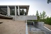 Modern home with Exterior, Concrete Siding Material, Glass Siding Material, House, Beach House Building Type, and Metal Siding Material. Wein House - Besonías Almeida arquitectos Photo 2 of Wein House