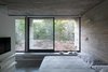 Modern home with Bedroom, Bed, Shelves, Accent Lighting, Wall Lighting, and Concrete Floor. Wein House - Besonías Almeida arquitectos Photo 12 of Wein House