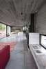 Modern home with Living Room, Sofa, Chair, Concrete Floor, Accent Lighting, Pendant Lighting, and Wood Burning Fireplace. Wein House - Besonías Almeida arquitectos Photo 9 of Wein House