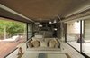 Modern home with Living Room, Sofa, Coffee Tables, Chair, Ceramic Tile Floor, Medium Hardwood Floor, Floor Lighting, Accent Lighting, and Recliner. S&S House - Besonías Almeida arquitectos Photo 11 of S&S House