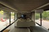 Modern home with Living Room, Sofa, Bench, Coffee Tables, Floor Lighting, Ceramic Tile Floor, Accent Lighting, and Medium Hardwood Floor. S&S House - Besonías Almeida arquitectos Photo 10 of S&S House