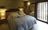 Modern home with Bedroom, Bed, Wall Lighting, Table Lighting, and Ceramic Tile Floor. S&S House - Besonías Almeida arquitectos Photo 14 of S&S House