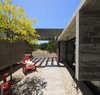 Modern home with Outdoor, Front Yard, Trees, Stone Patio, Porch, Deck, and Concrete Patio, Porch, Deck. S&S House - Besonías Almeida arquitectos Photo 7 of S&S House
