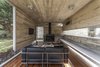Modern home with Living Room, Sofa, Coffee Tables, Wood Burning Fireplace, and Medium Hardwood Floor. Torcuato House Pavilion - Besonías Almeida arquitectos Photo 5 of Torcuato House Pavilion