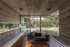 Modern home with Living Room, Sofa, Accent Lighting, Chair, Concrete Floor, and Medium Hardwood Floor. Torcuato House Pavilion - Besonías Almeida arquitectos Photo 6 of Torcuato House Pavilion