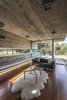 Modern home with Living Room, Sofa, Coffee Tables, Accent Lighting, Medium Hardwood Floor, and Concrete Floor. Torcuato House Pavilion - Besonías Almeida arquitectos Photo 7 of Torcuato House Pavilion