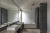 Modern home with Bath Room, Concrete Counter, Concrete Floor, Drop In Sink, Undermount Tub, Accent Lighting, Glass Tile Wall, Two Piece Toilet, and Enclosed Shower. Aranzazu House - Besonías Almeida arquitectos Photo 19 of Aranzazu House