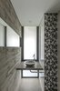 Modern home with Bath Room, Concrete Counter, Concrete Floor, Drop In Sink, Glass Tile Wall, Two Piece Toilet, and Accent Lighting. Aranzazu House - Besonías Almeida arquitectos Photo 20 of Aranzazu House