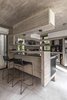 Modern home with Kitchen, Ceramic Tile Floor, Granite Counter, Stone Slab Backsplashe, Laminate Cabinet, Accent Lighting, and Concrete Backsplashe. Aranzazu House - Besonías Almeida arquitectos Photo 13 of Aranzazu House