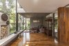 Modern home with Living Room, Chair, Sofa, Medium Hardwood Floor, Wood Burning Fireplace, Coffee Tables, and Accent Lighting. Aranzazu House - Besonías Almeida arquitectos Photo 9 of Aranzazu House