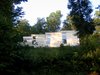 Modern home with Exterior, House Building Type, Metal Roof Material, Concrete Siding Material, and Shed RoofLine. exterior from base of hill Photo of Leesburg House