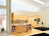Modern home with Kitchen, Refrigerator, Cooktops, Microwave, Granite Counter, Wood Cabinet, Light Hardwood Floor, and Ceiling Lighting. kitchen Photo 2 of Leesburg House