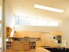 Modern home with Kitchen, Refrigerator, Wall Oven, Microwave, Dishwasher, Granite Counter, Wood Cabinet, Light Hardwood Floor, Ceiling Lighting, and Drop In Sink. kitchen Photo 5 of Leesburg House