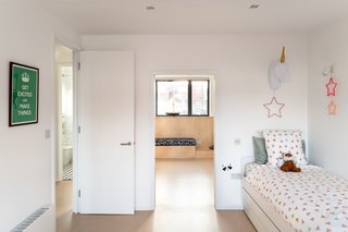 Built for the couple's twins, the children's bedrooms are a mirror of one another. While each child has their own personalized space, a "secret" door within the adjoining room gives the twins the choice to unify the floor into a giant play area.