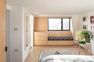 On the upper levels, the bedrooms feature bespoke storage and seating, using with the same language and material as the living area below.